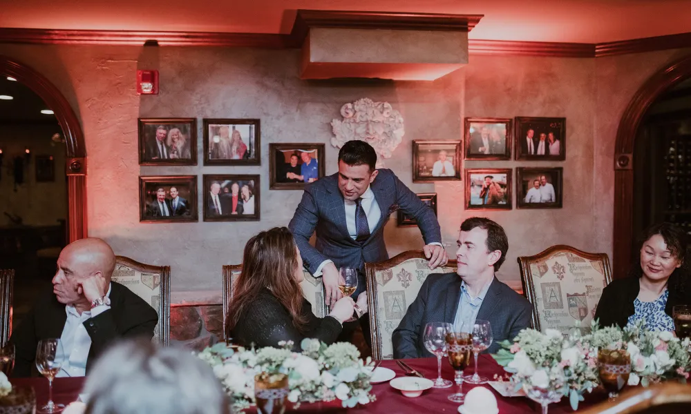 Robby Younes talking with guests in The Wine Cellar.