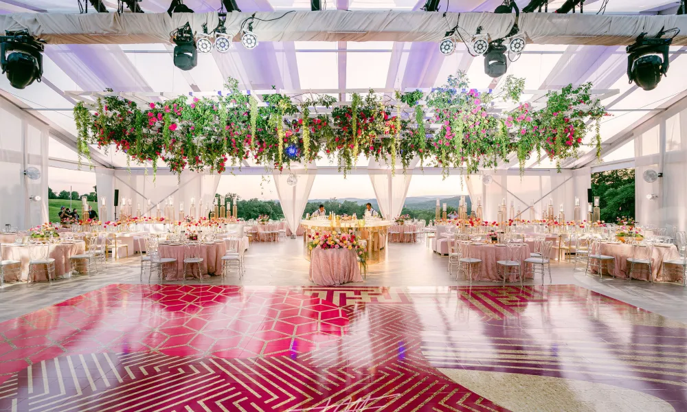 Wedding reception featuring pink dance floor and florals in Big Sky Pavillion.