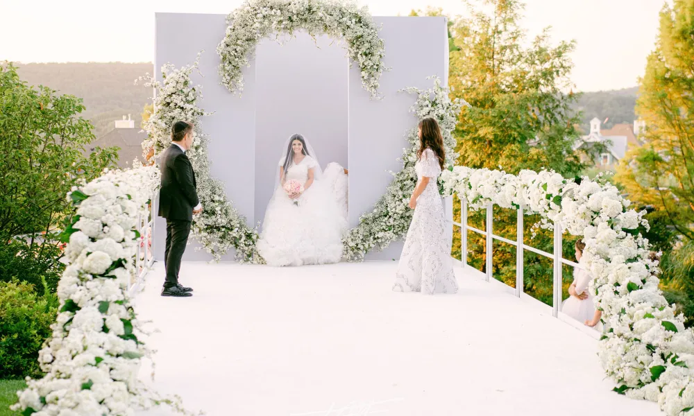 Bride walking down aisle during wedding ceremony in amphitheater. 