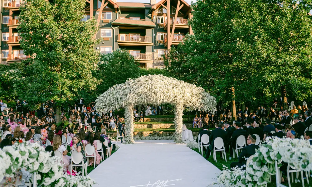 White aisle of wedding ceremony in outdoor amphitheater.