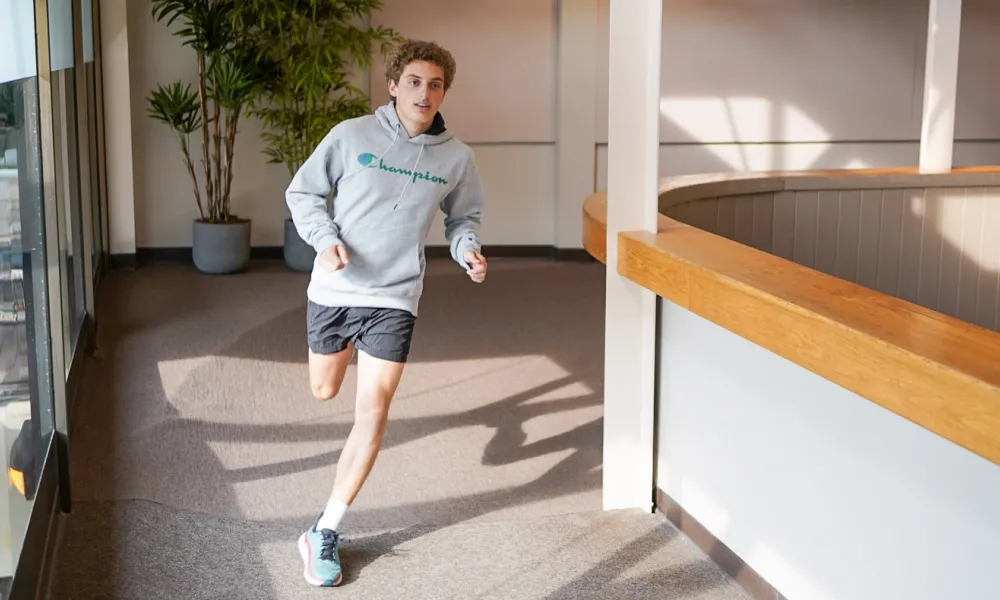 Man running on indoor running track at Minerals Sports Club.