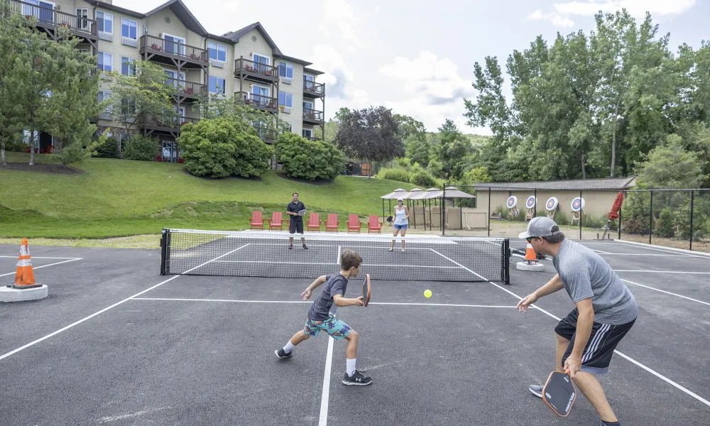 Family playing pickleball.