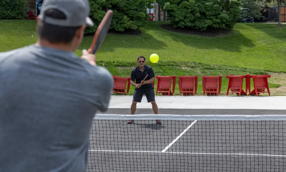 Two men playing pickleball.