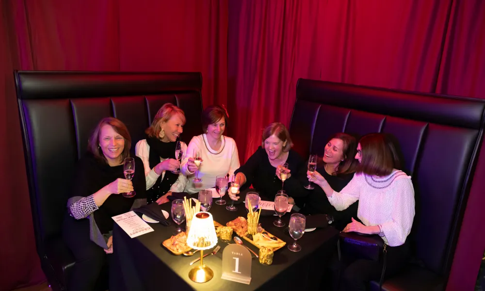 Group of girlfriends enjoying drinks at Crystal Cabaret. 