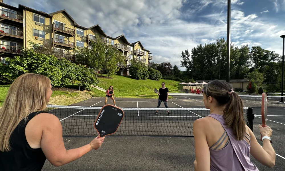 Group of women playing pickleball.