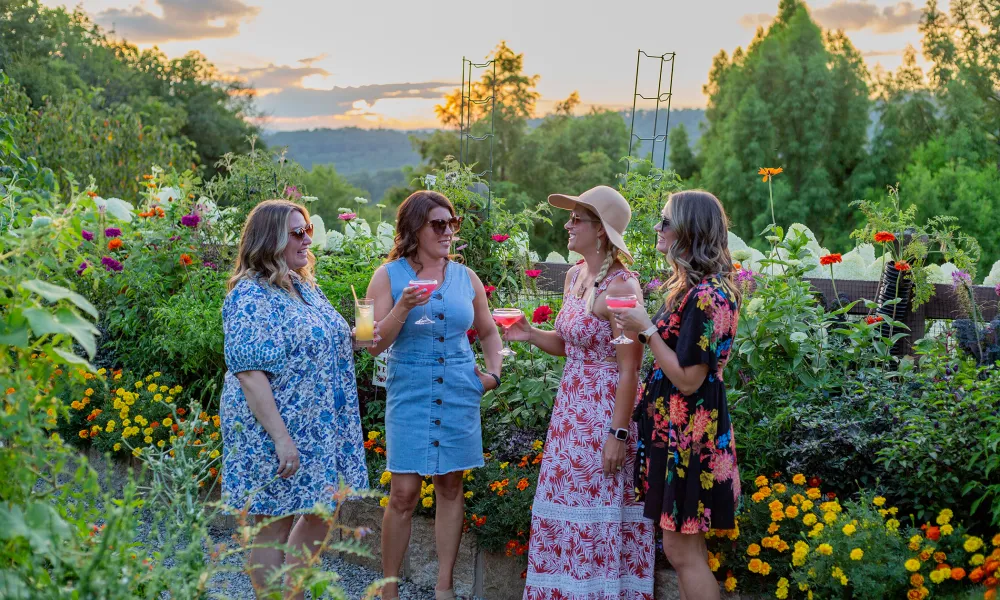 Group of 4 girlfriends standing in Chef's Garden.