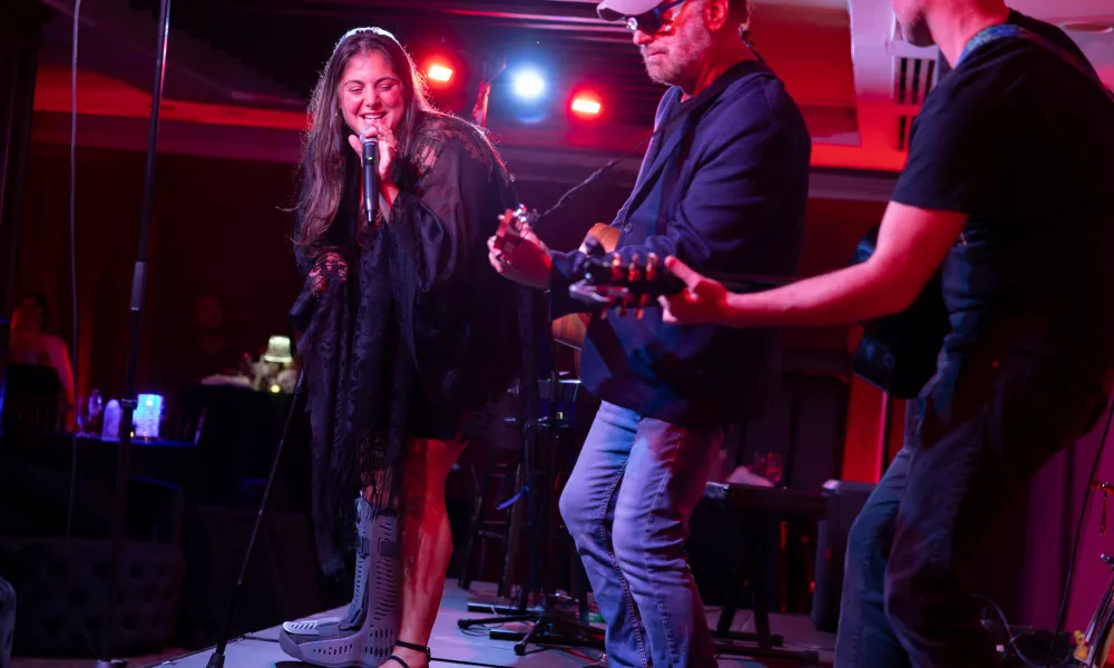 Singer and two guitar players on stage at Crystal Cabaret.