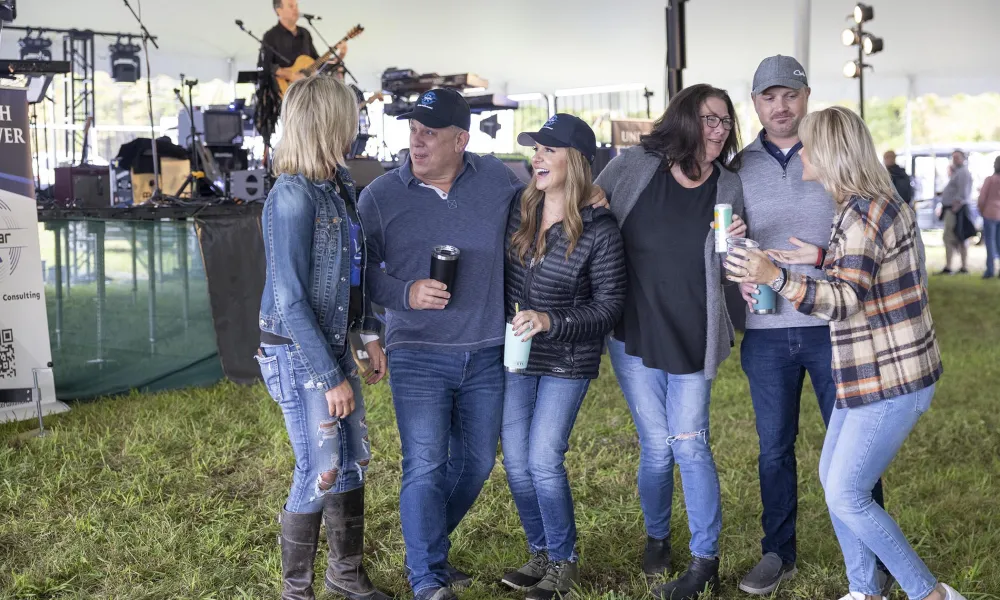 Group of friends laughing together at music fest.