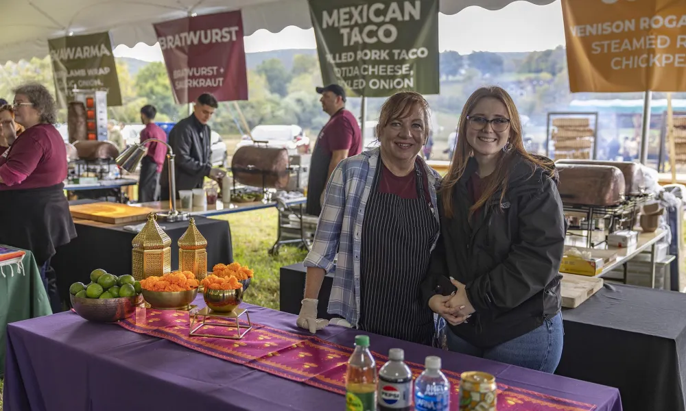 Two woman helping to pass out food at Music Fest.