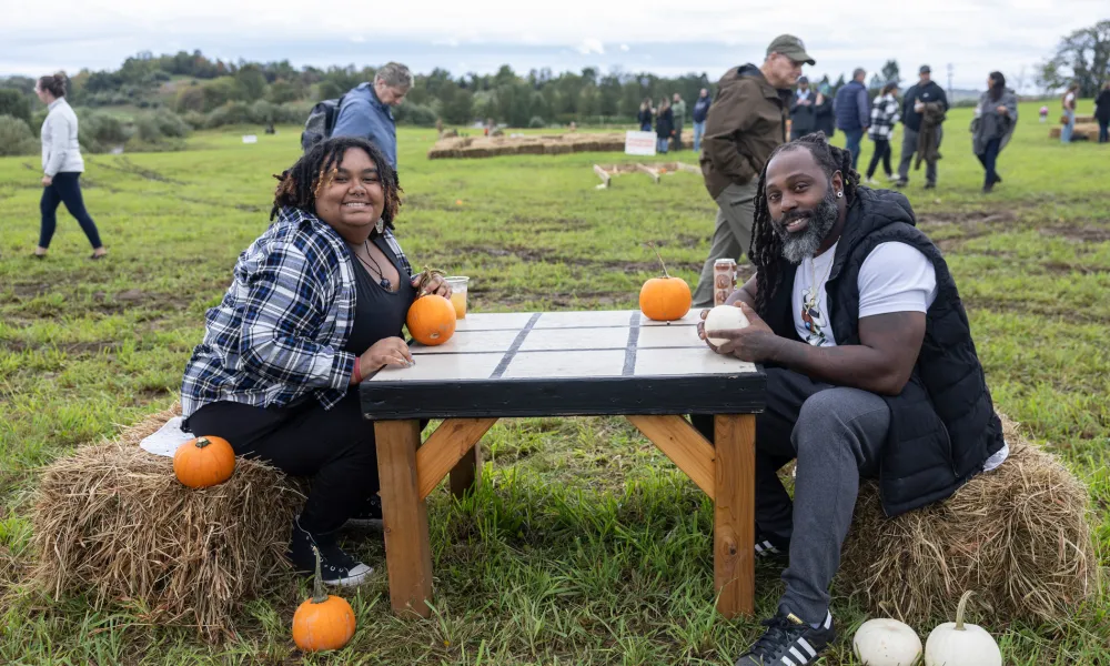 Woman and man playing tic tac toe with pumpkins 