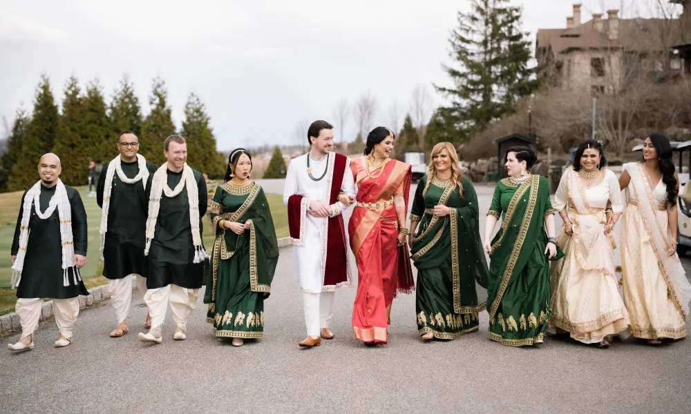 Indian wedding party with bride and groom walking near Crystal Springs Clubhouse