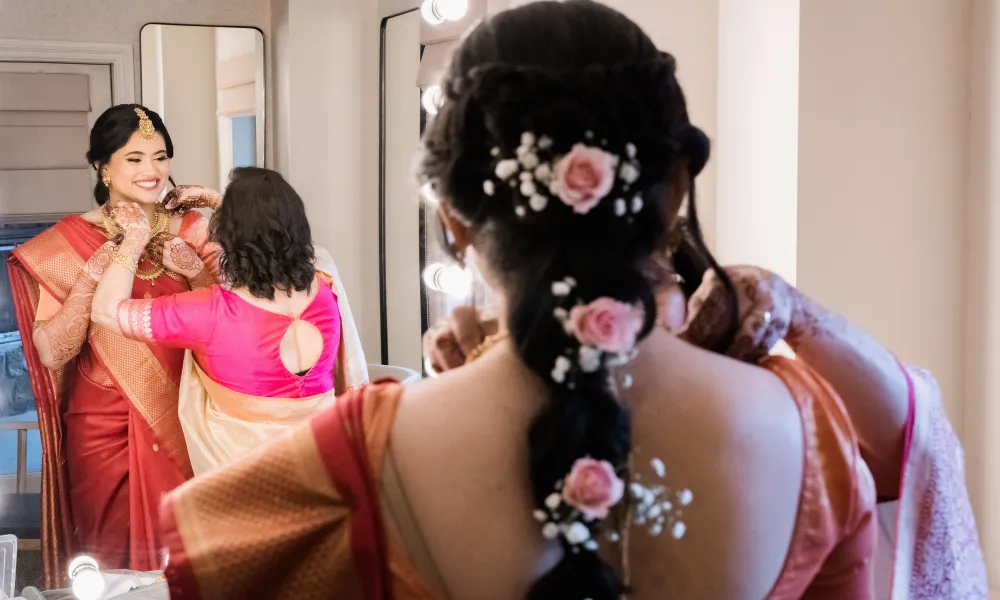 Indian bride's hair featuring pink flowers.