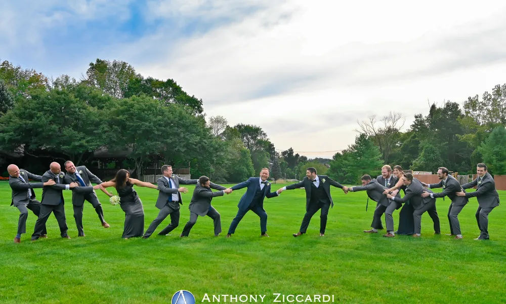 Grooms being pulled by their wedding party.