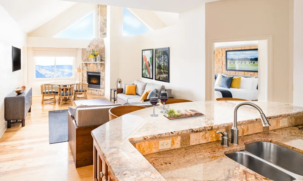 Kitchen sink and view of living room and fireplace in the 2-Bed 2 Bath Unique Cascades Sunset Lookout