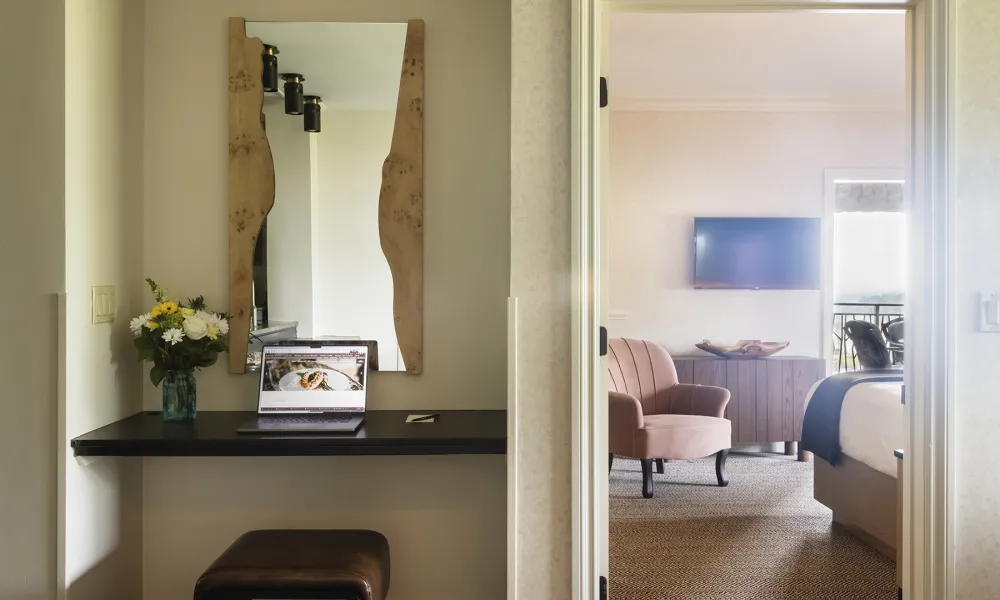 Desk area looking into bedroom in hotel suite