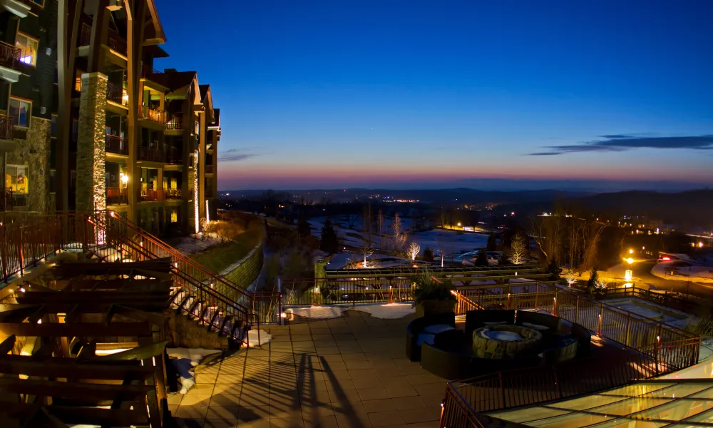 Nightime shot of fire and water terrace at Grand Cascades Lodge. 