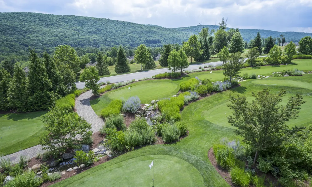 Natural grass putting course and mountain view at Grand Cascades Lodge.