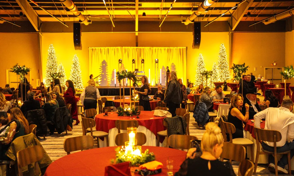 Round tables with people dining set up in Canyon Ballroom.