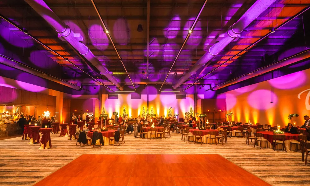 Canyon Ballroom dance floor with round tables and lights on ceiling.