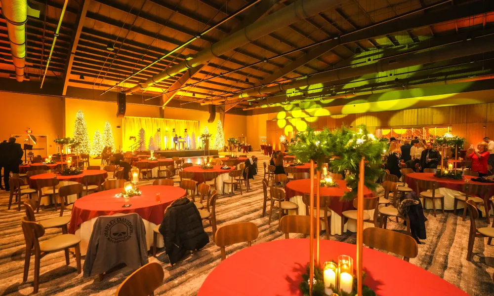 Round tables with red tablecloths set up in Canyon Ballroom.