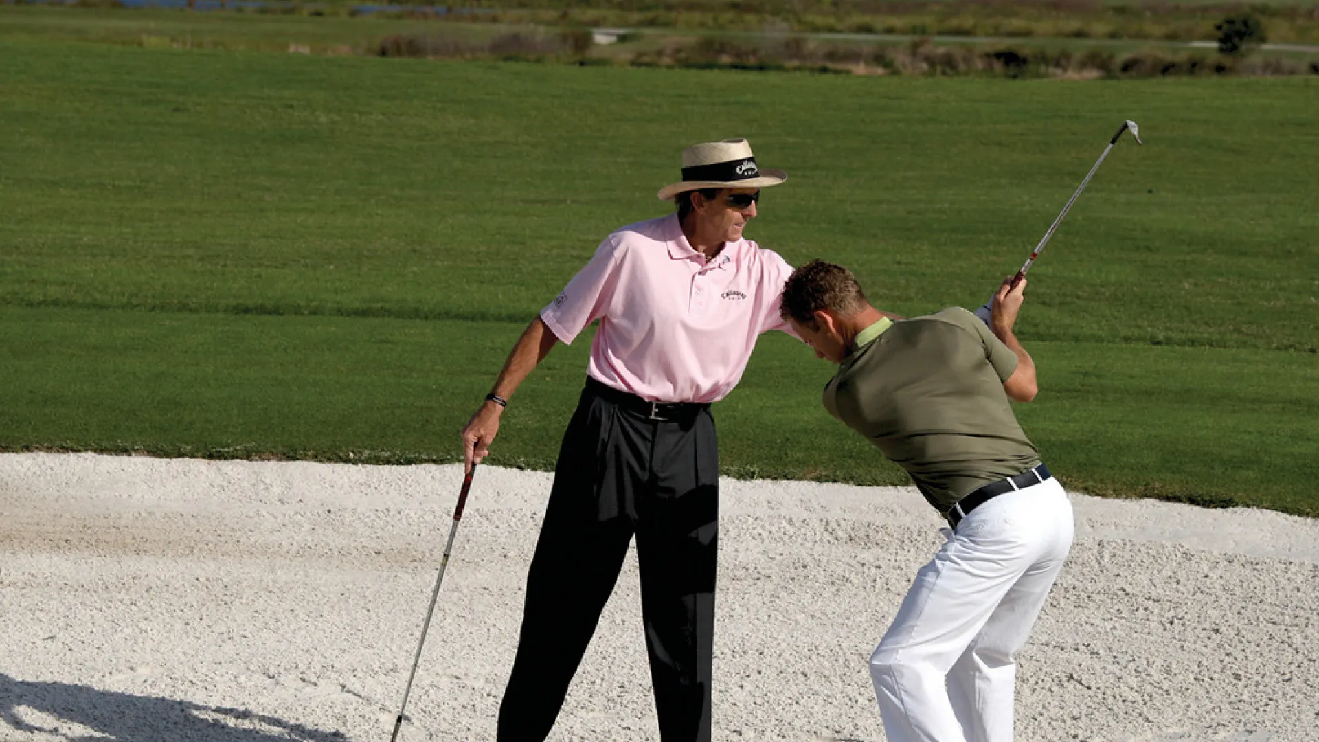 David Leadbetter teaching man how to golf at Crystal Springs Resort