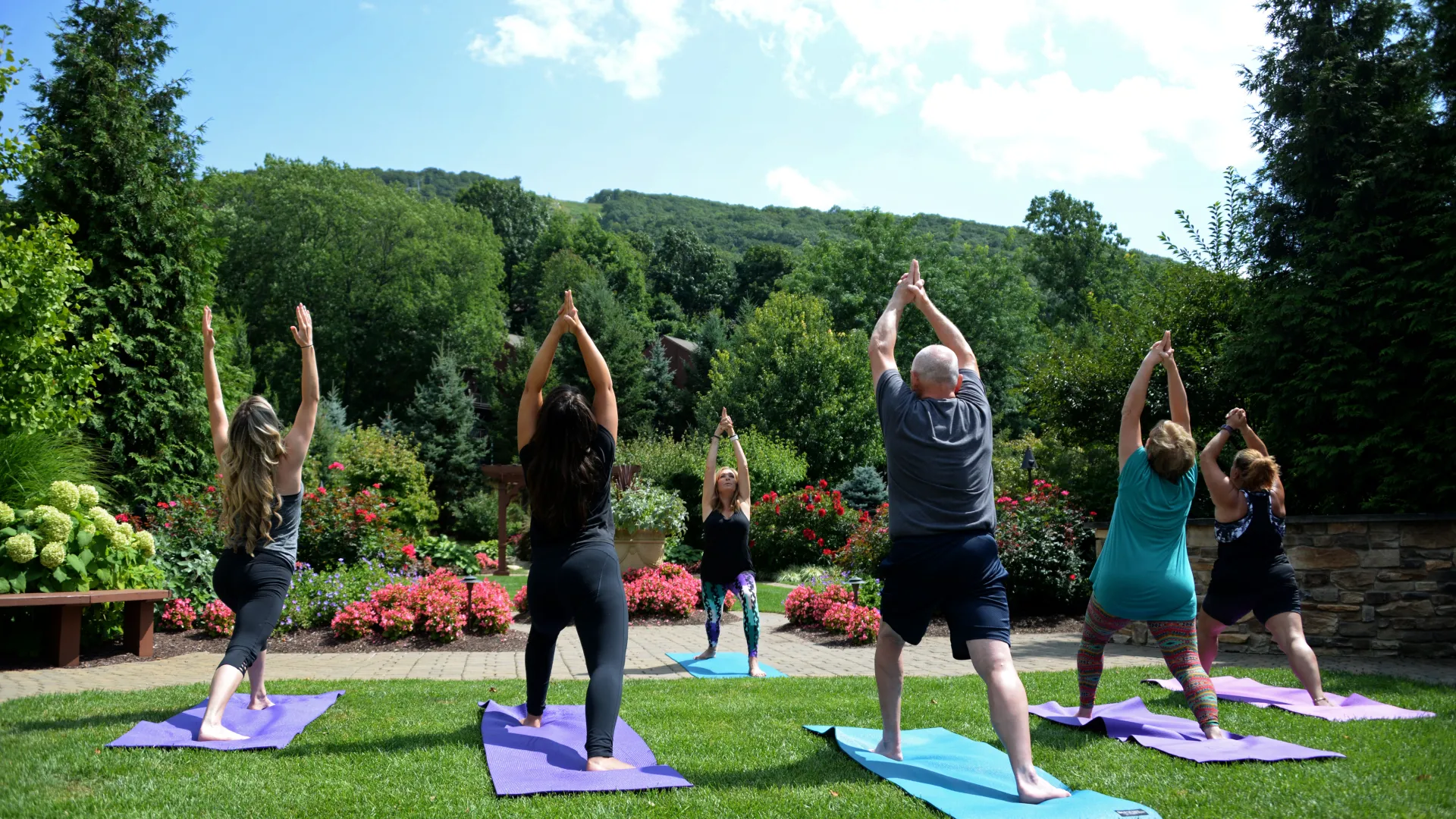  Outdoor Yoga Class surrounded by greenery