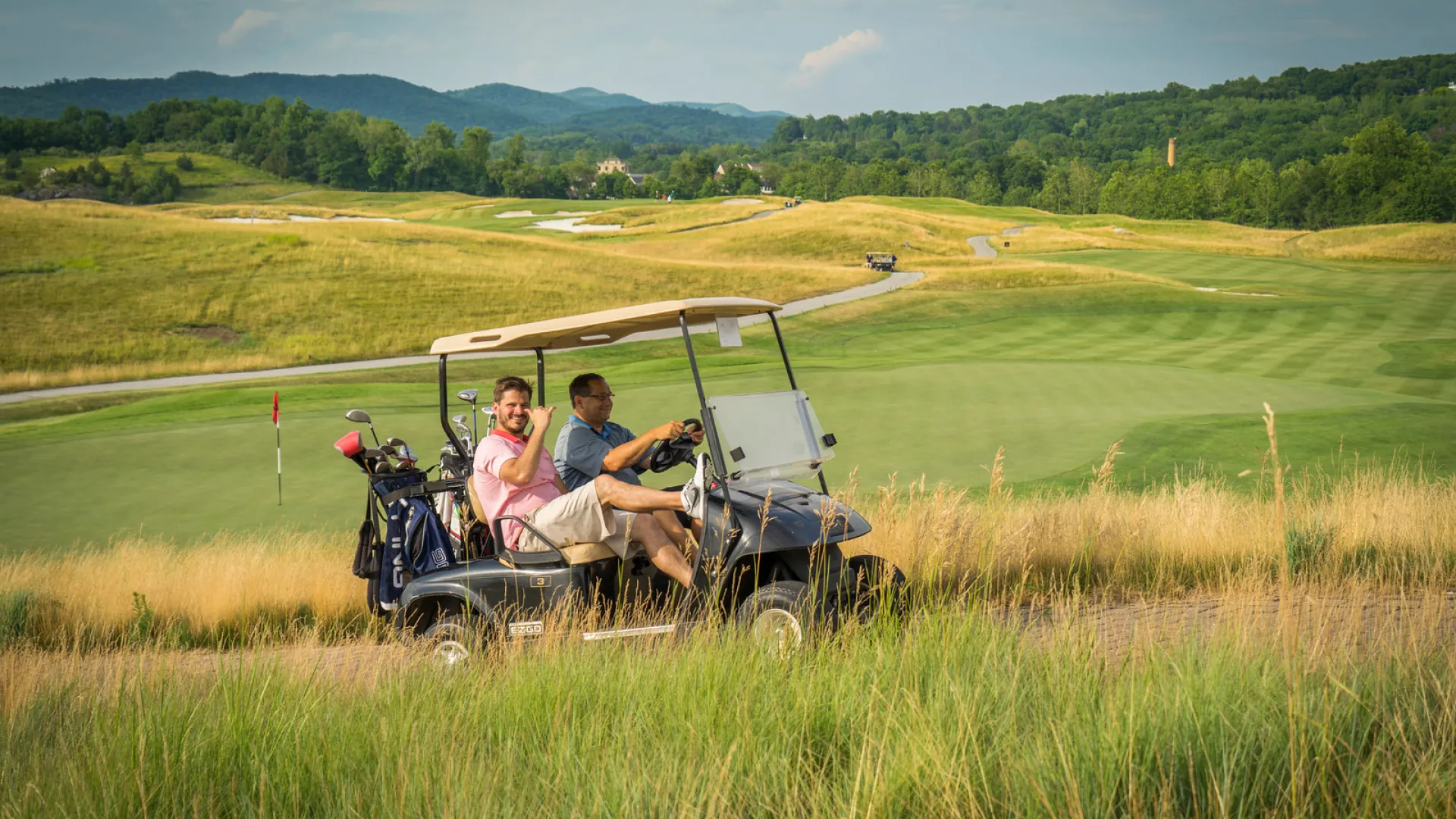 Guys riding on a golf cart at Ballyowen