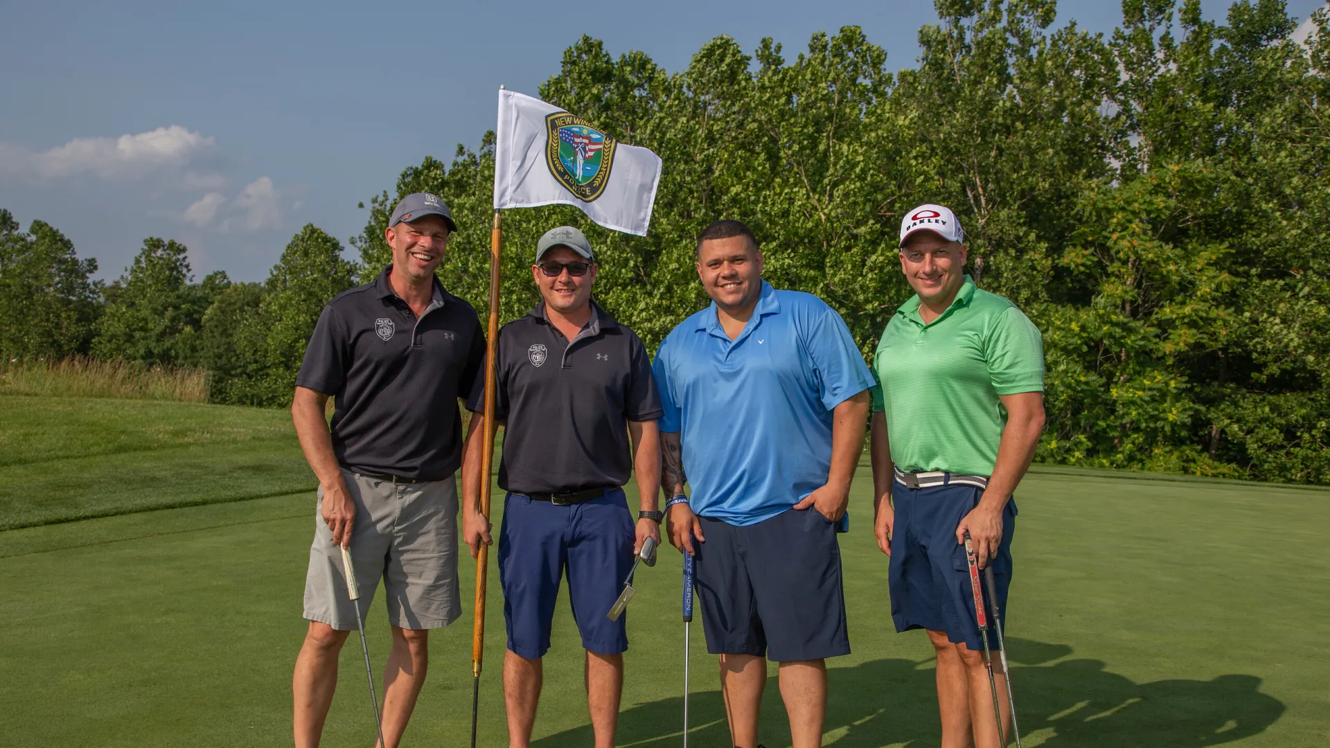 Four guys standing with a law enforcement golf flag at Ballyowen Golf course