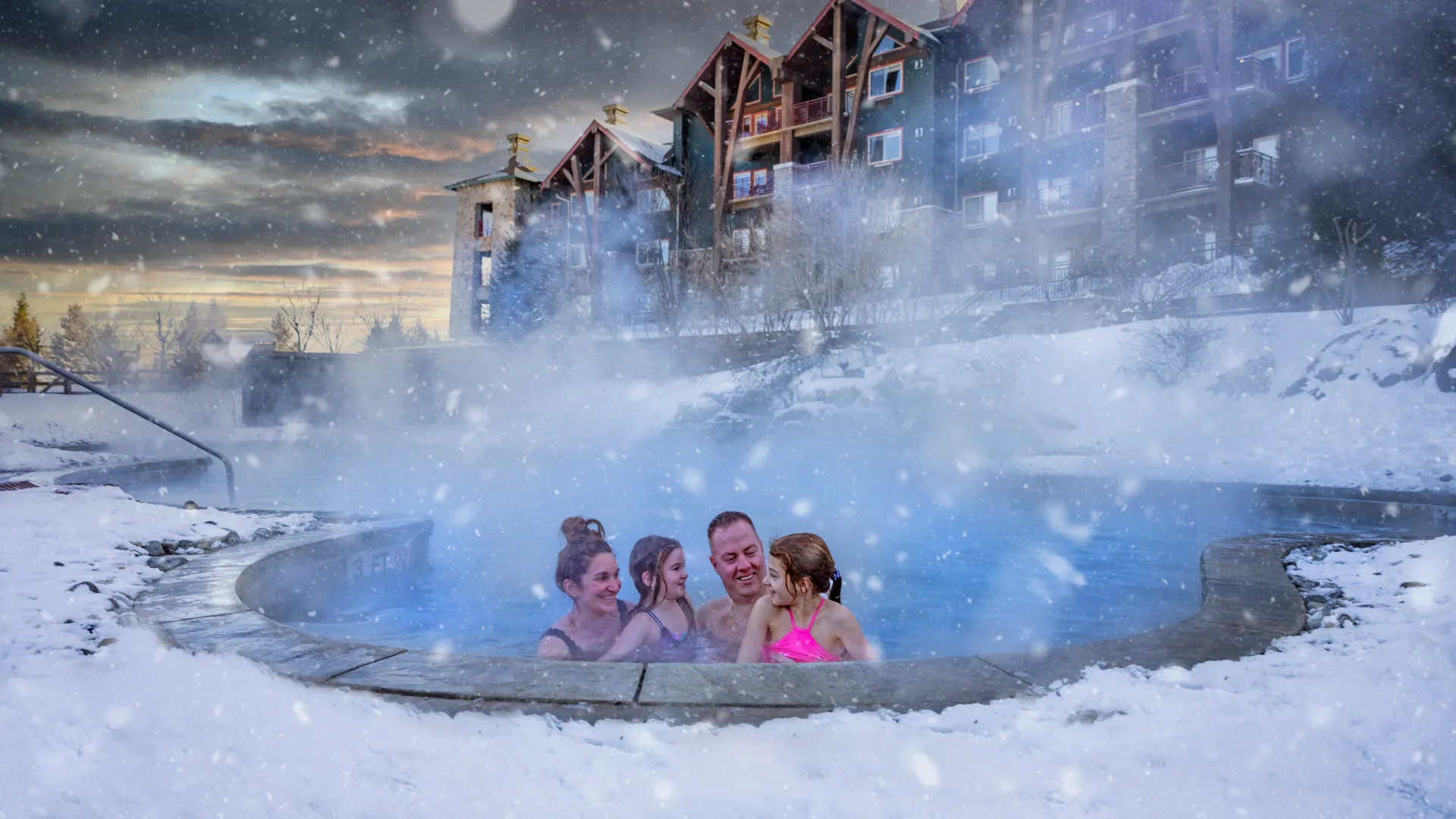 Family enjoying snow pool at Grand Cascades Lodge