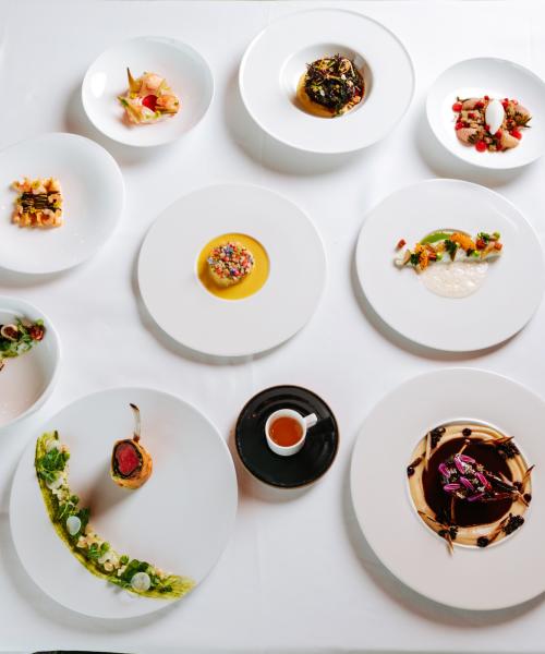 Array of Restaurant Latour food dishes displayed on white tablecloth.