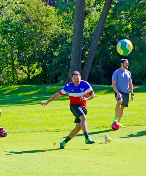 Friends playing a round of foot golf at a resort close to NYC