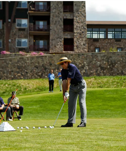 Man golfing at a driving range at Crystal Springs Resort