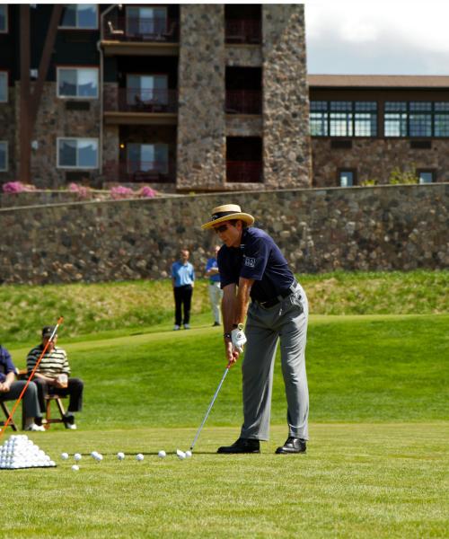 Man golfing at a driving range at Crystal Springs Resort