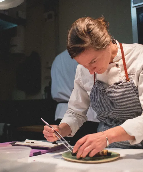 Chef Aishling Stevens plating a dish in Latour