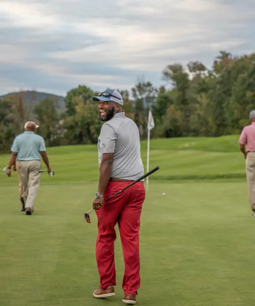 Golfers walking on a golf course.