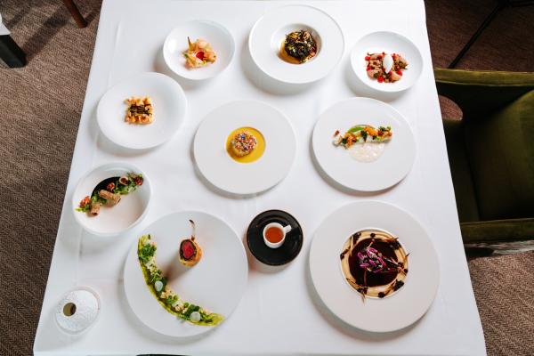 Array of Restaurant Latour food dishes displayed on white tablecloth.