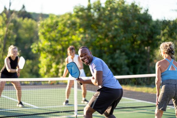 Four people playing pickleball