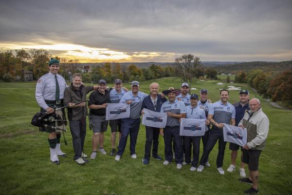 Ballyowen Law Enforcement Open golfers stand with Kelsey Grammer. 