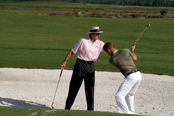 David Leadbetter teaching man how to golf at Crystal Springs Resort