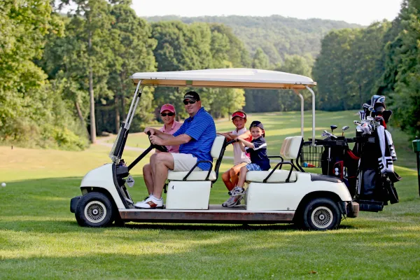 Parents with their kids on a family friendly golf course at Crystal Springs Resort in New Jersey.