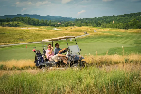 Guys riding on a golf cart at Ballyowen