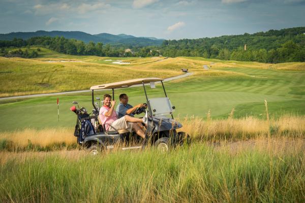 Guys riding on a golf cart at Ballyowen