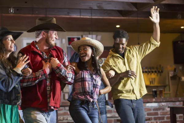 Group of people line dancing. 