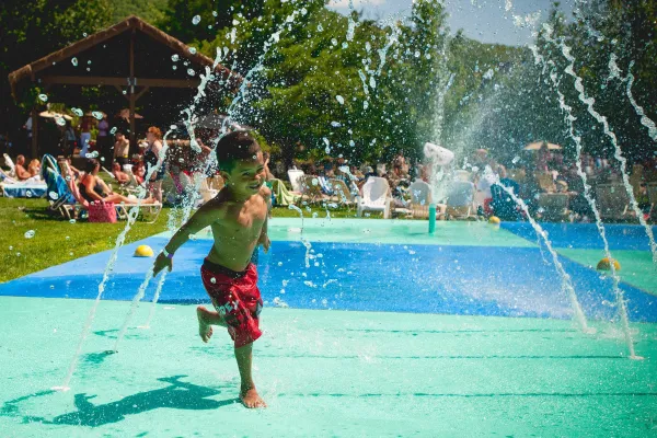 Child running through spray ground at Minerals Hotel