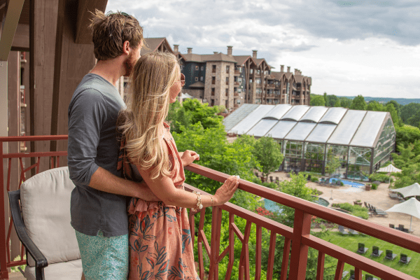 Couple enjoying breakfast while overlooking their balcony view from Grand Cascades Lodge