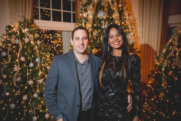 Couple in front of Christmas tree decorations