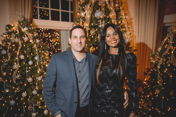 Couple in front of Christmas tree decorations