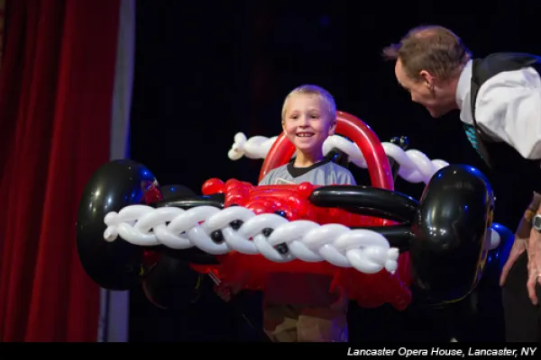 Balloon artist, John Cassidy, on stage with car made out of balloons.