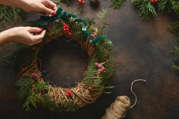 Wreath decorating with twine and berries.