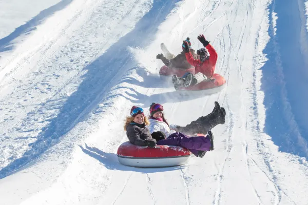 People snowtubing.